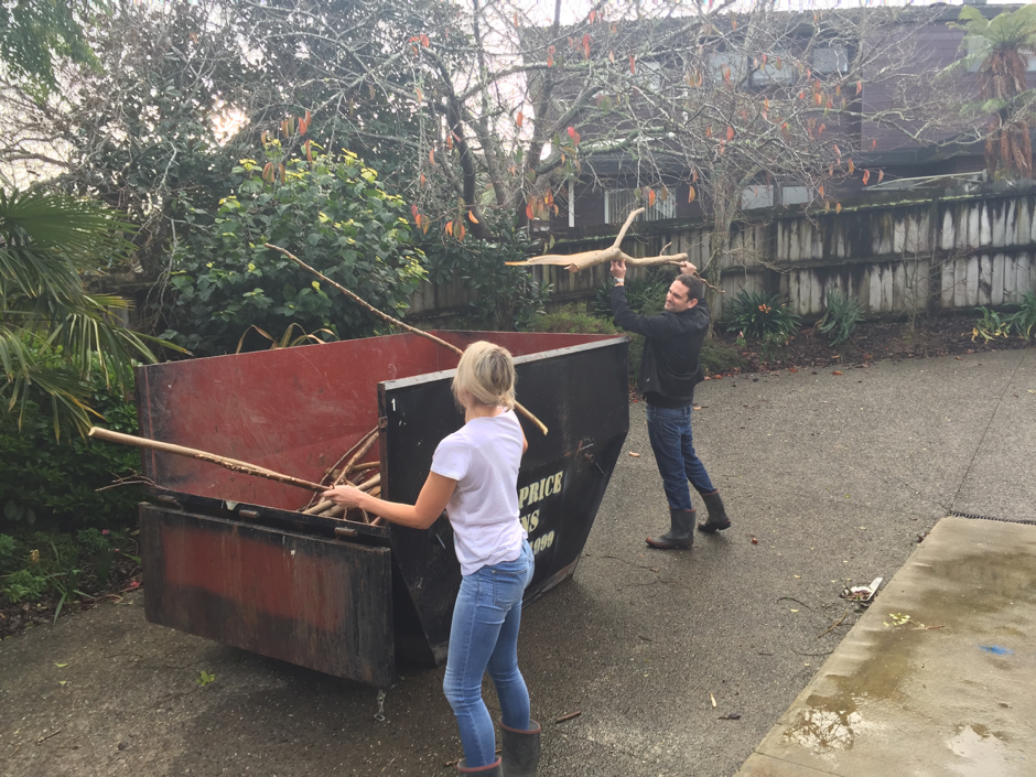 Man and a woman filling a cut price bins bin